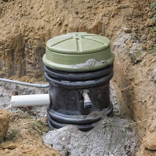 a grinder pump in a ditch