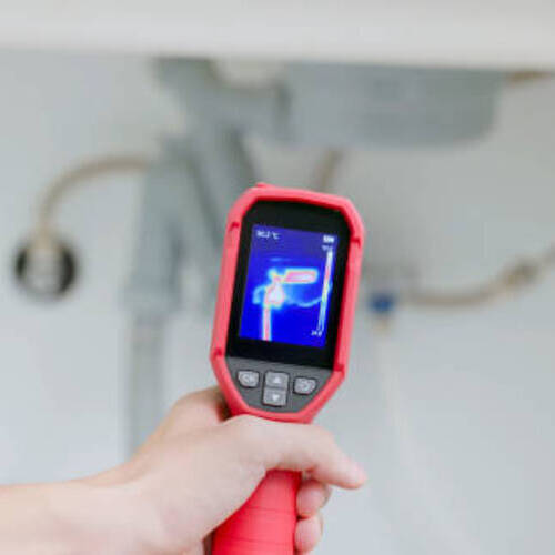 close up male home inspector is using thermal imager to check water leakage